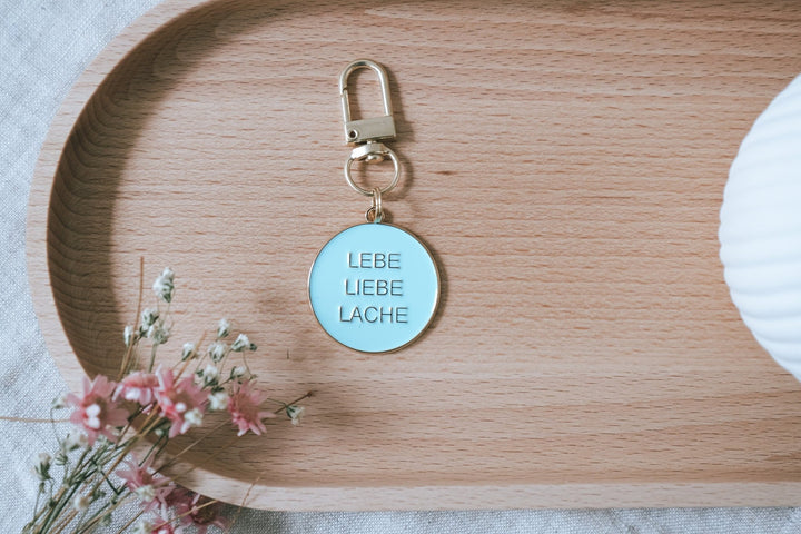 Schlüsselanhänger "Lebe Liebe Lache" aus Metall in türkis und gold - Jellies Design